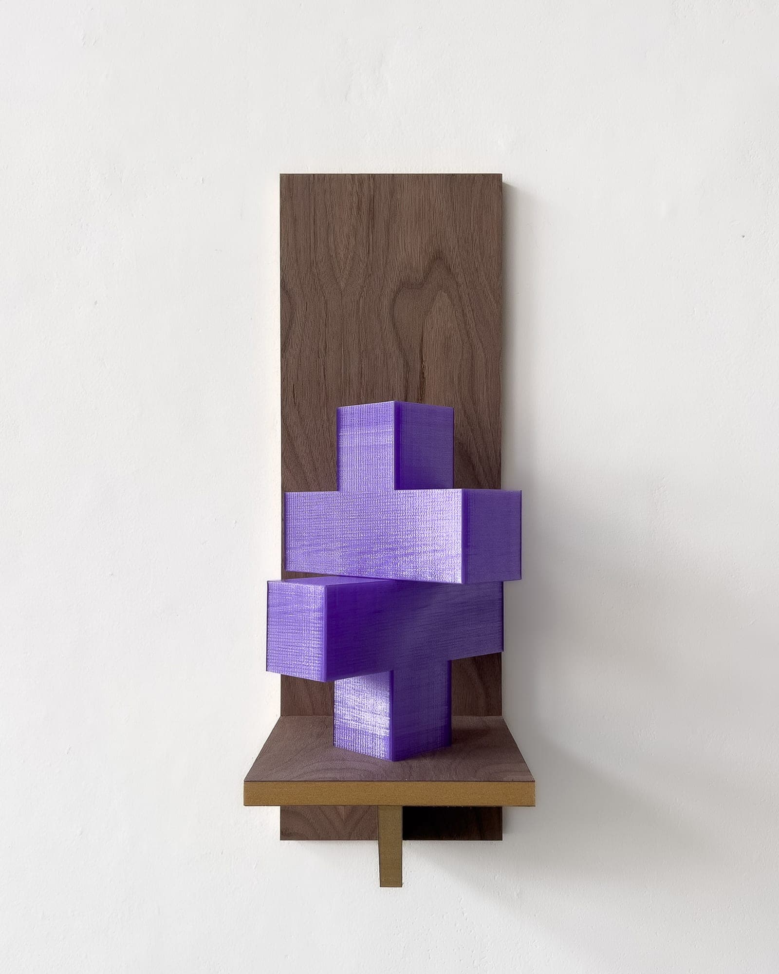 Wall-mounted walnut panel sculpture with an interlocking violet 3D-printed cross form