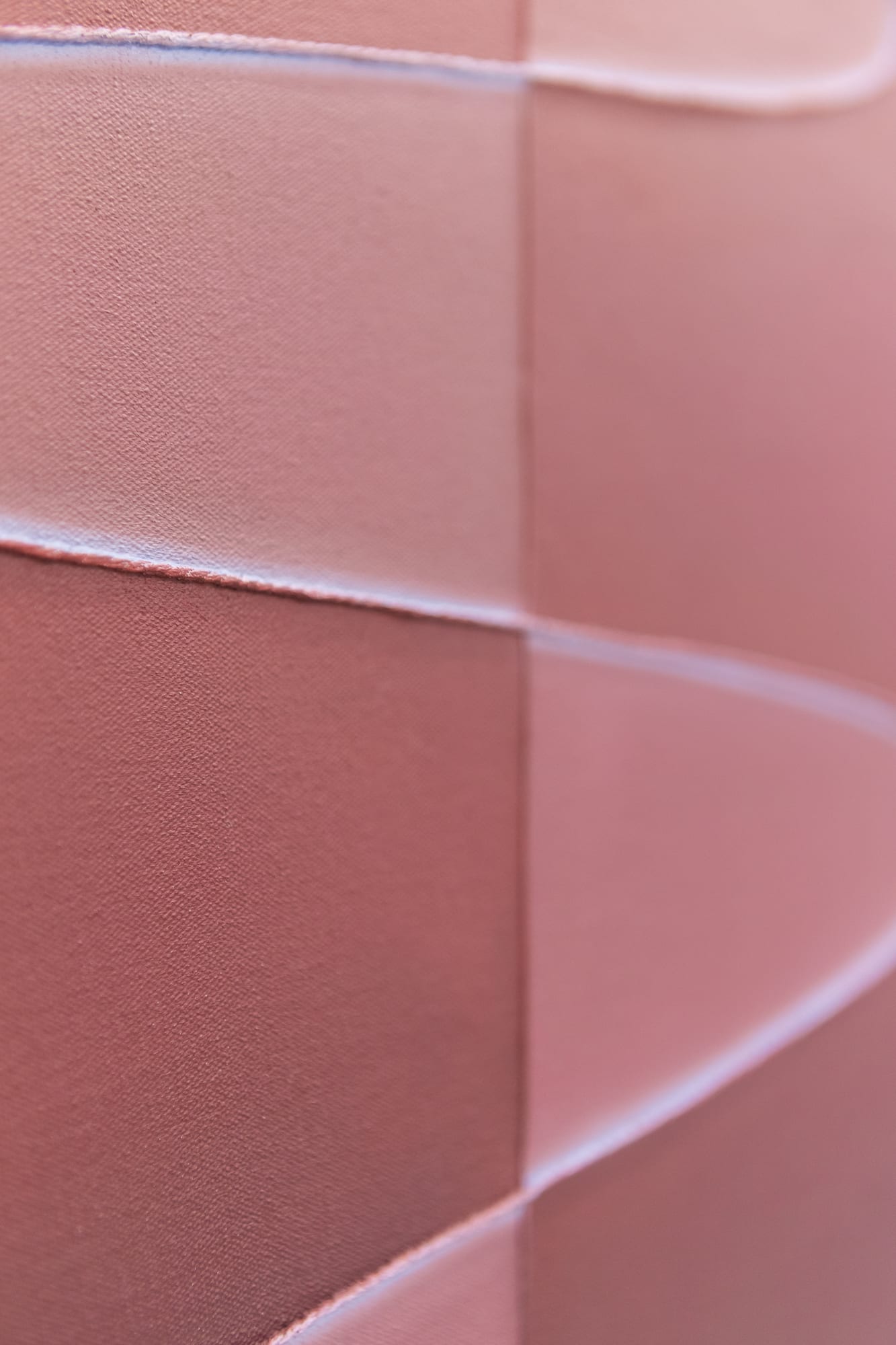 Macro detail of the maroon ribbon painting surface