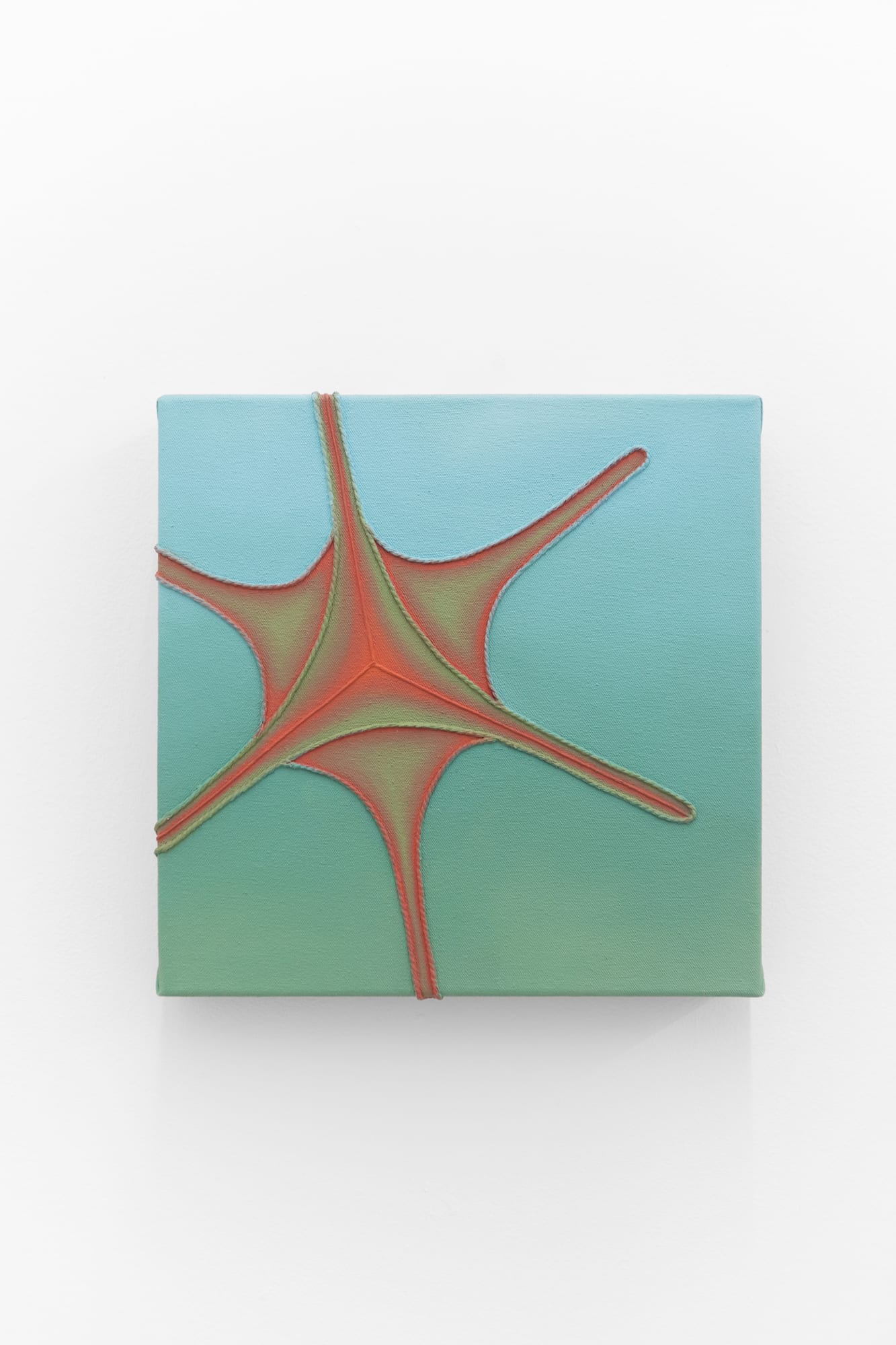 Teal painting with a soft red and yellow star burst at the center