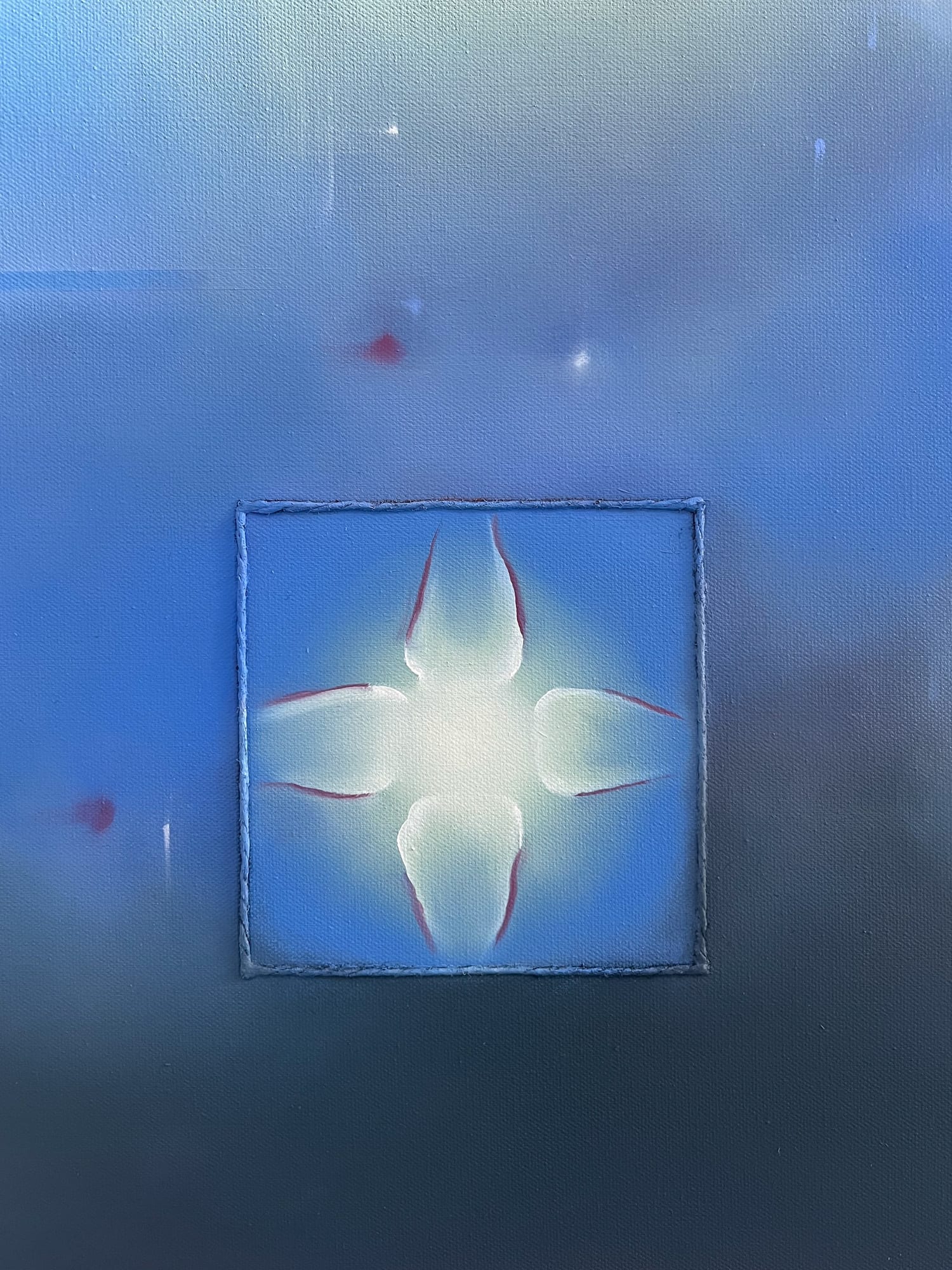 Close-up of a blue painted surface with a small luminous form